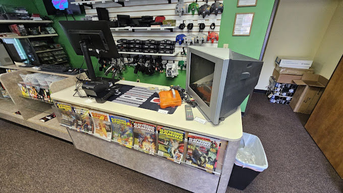 The counter of a gaming store with a hooked up N64.